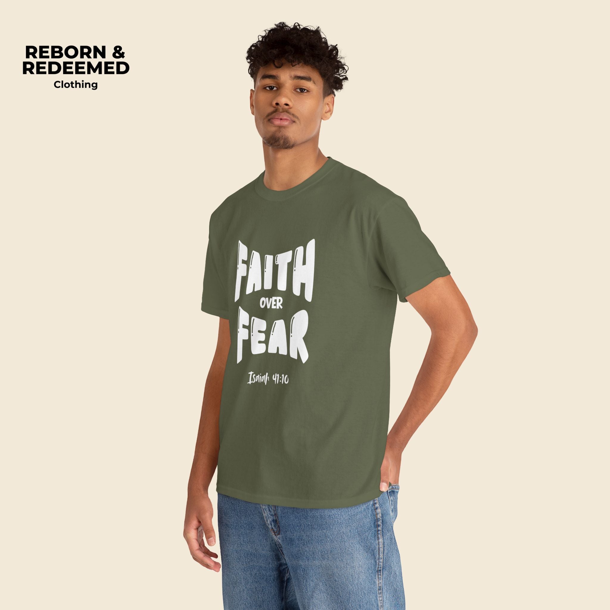Man wearing a green t-shirt with 'Faith Over Fear' text, standing against a beige background. | Military Green